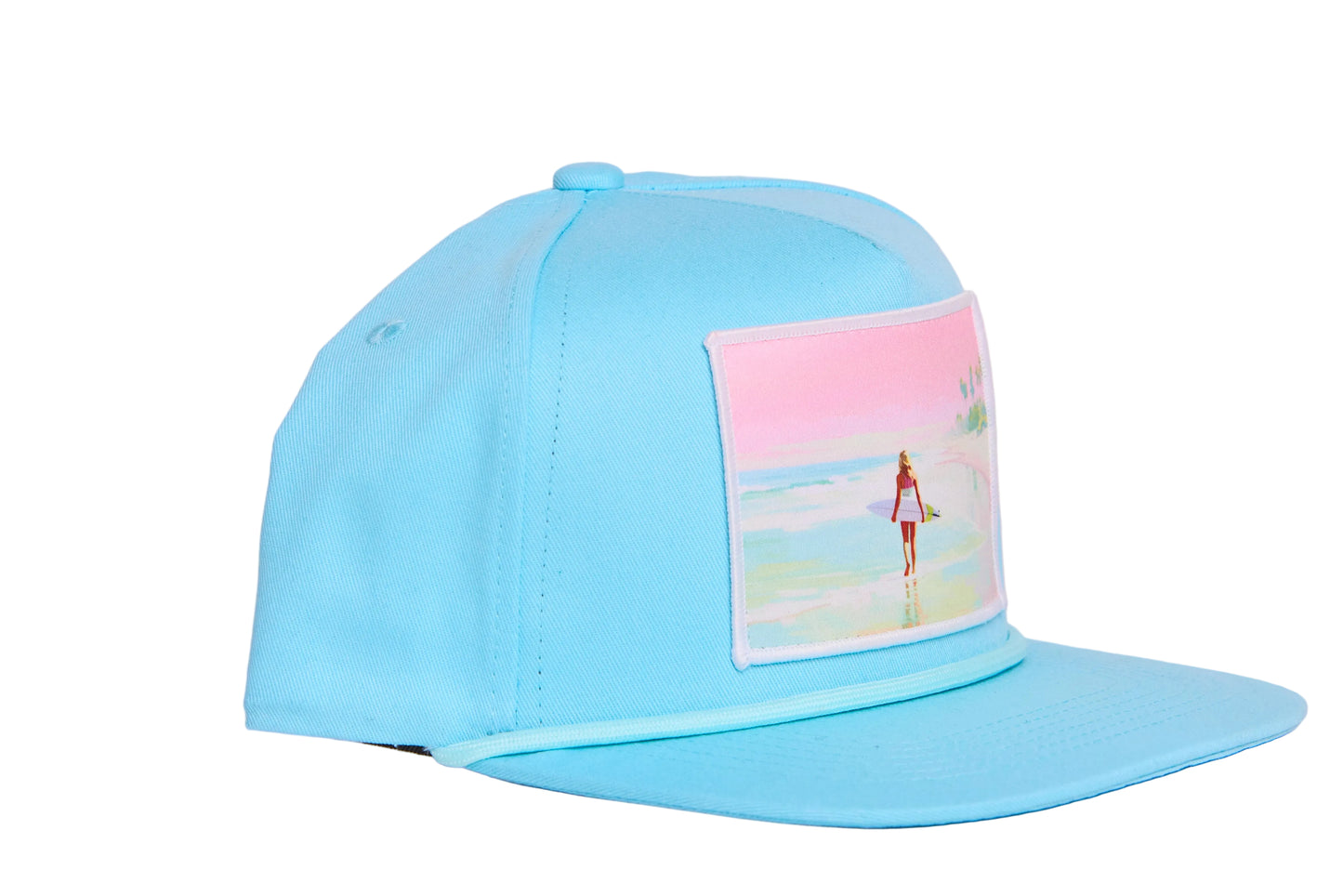 Baby blue flat bill hat with a timeless scene of a woman walking along a beach whilst carrying a surfboard