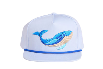 Light grey flat-bill hat with embroidered blue whale design and a breaking wave design on the underside of the bill