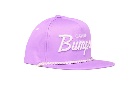Lavender flat bill hat with 'Caviar Bumps' text on a white background