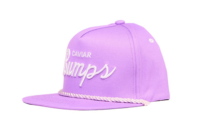 Lavender flat bill hat with 'Caviar Bumps' text on a white background