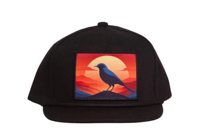 Black hat with a patch of a crow at sunset
