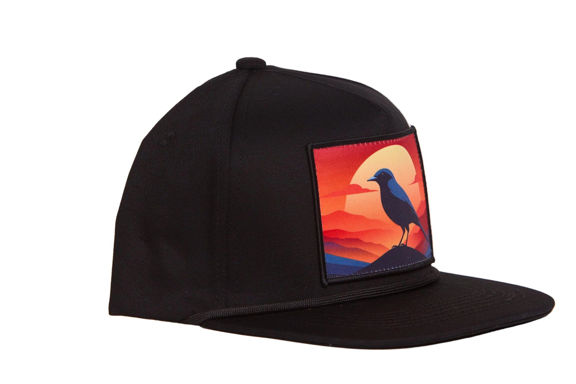 Black hat with a patch of a crow at sunset