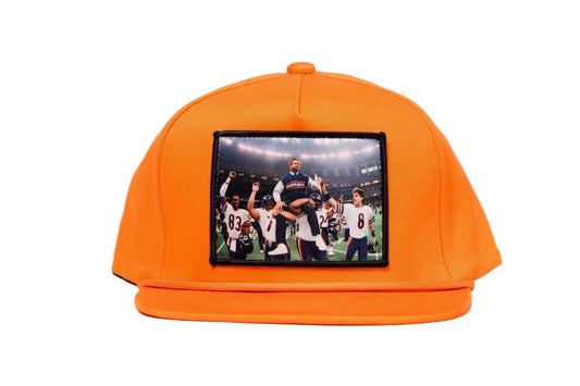 Orange hat featuring Mike Ditka being carried off the field by the 1985 Bears after winning Super Bowl XX