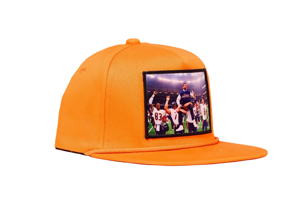 Orange hat featuring Mike Ditka being carried off the field by the 1985 Bears after winning Super Bowl XX