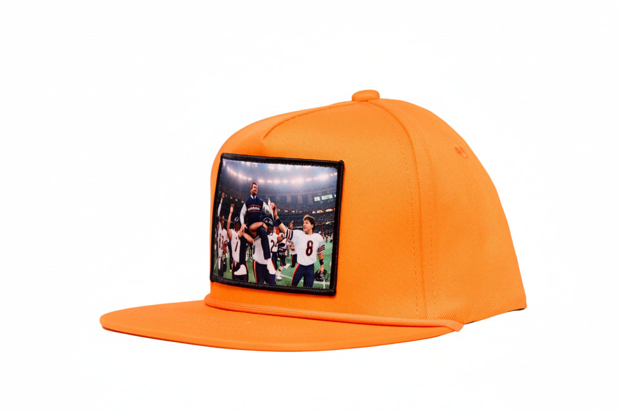 Orange hat featuring Mike Ditka being carried off the field by the 1985 Bears after winning Super Bowl XX