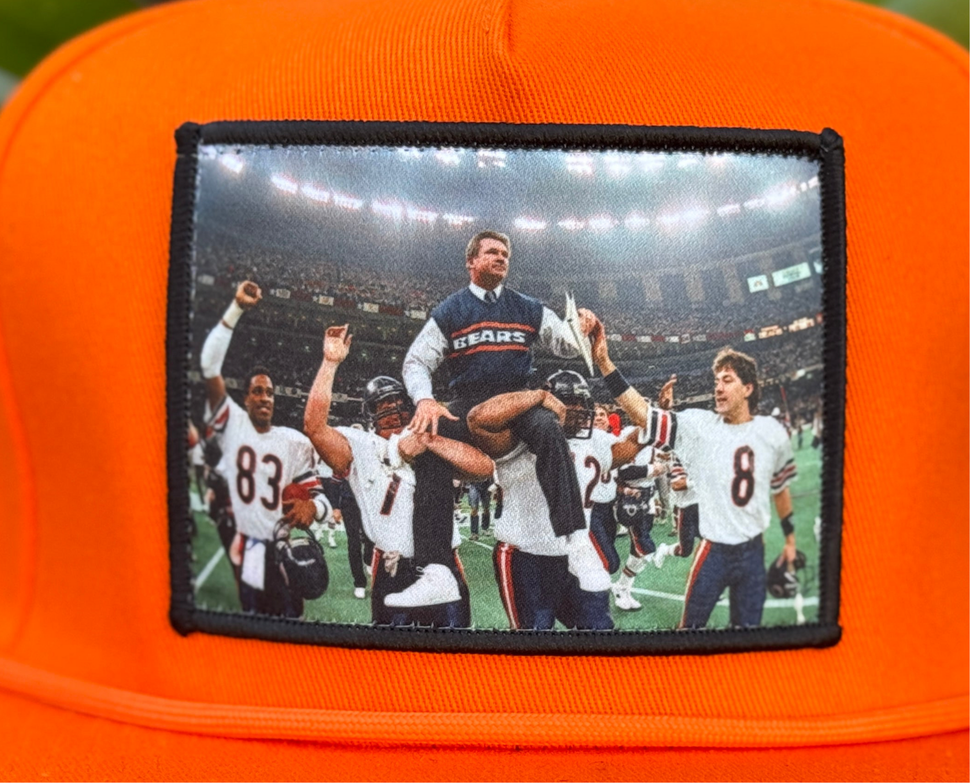Orange hat featuring Mike Ditka being carried off the field by the 1985 Bears after winning Super Bowl XX