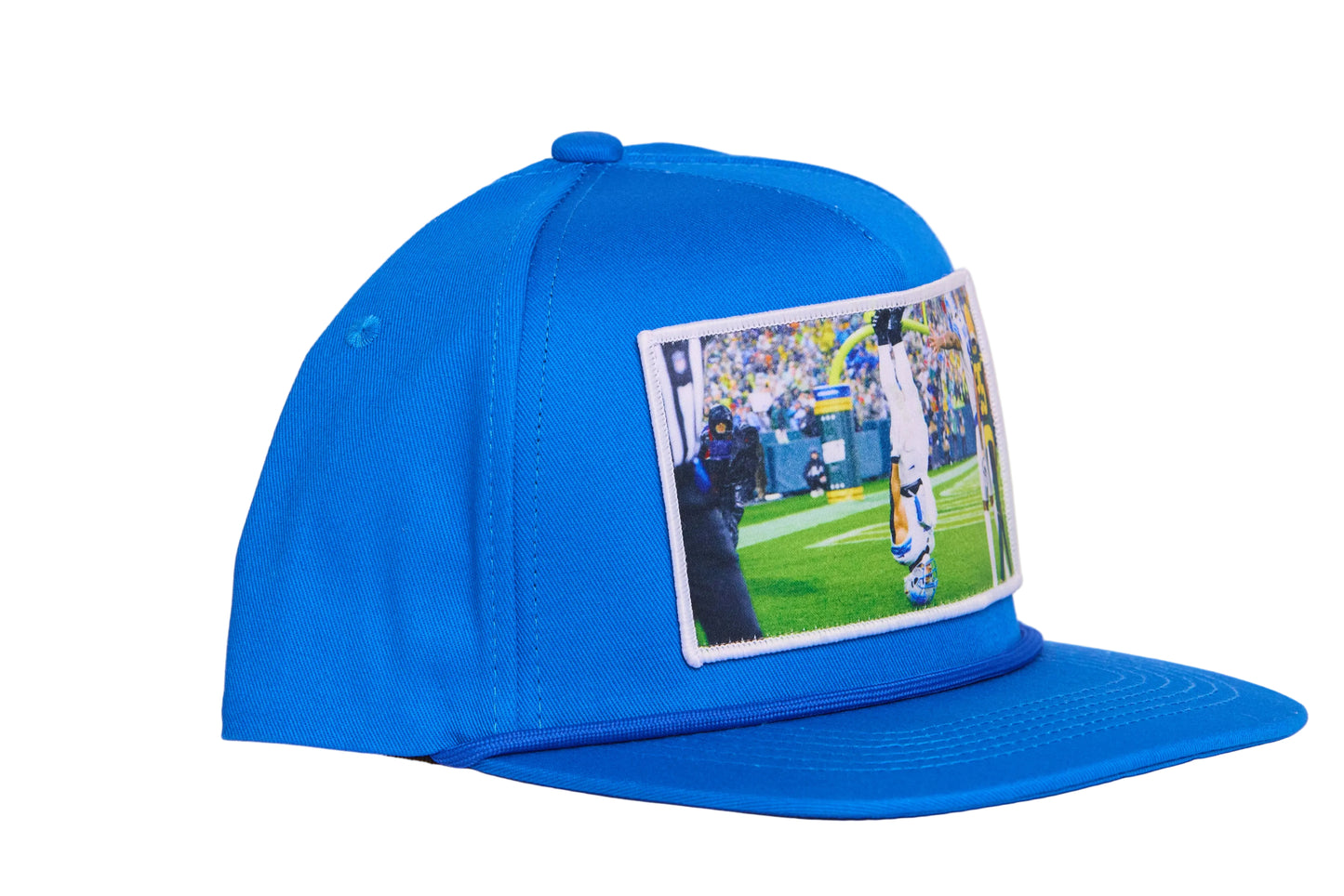 A Honolulu Blue hat featuring the iconic headstand celebration by Amon-Ra St. Brown