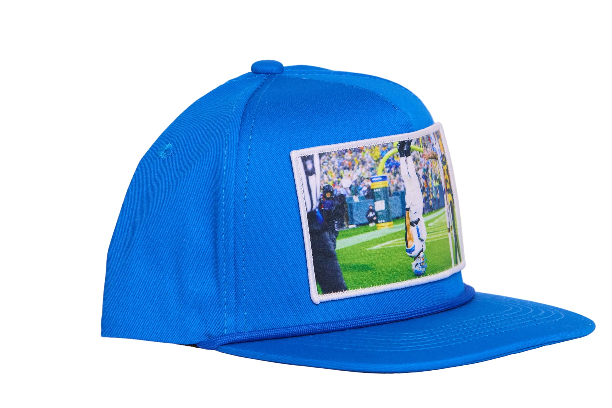 A Honolulu Blue hat featuring the iconic headstand celebration by Amon-Ra St. Brown