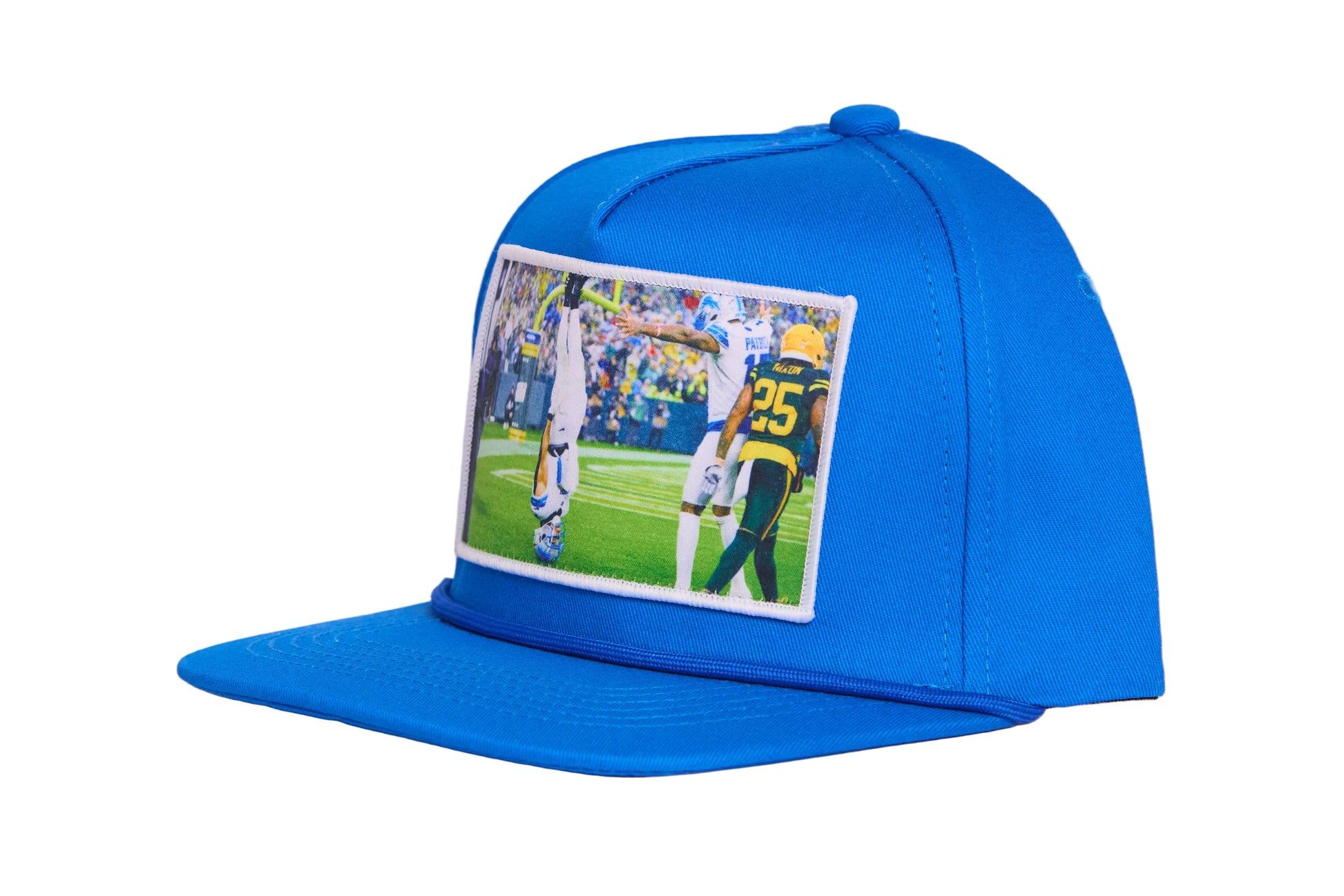 A Honolulu Blue hat featuring the iconic headstand celebration by Amon-Ra St. Brown