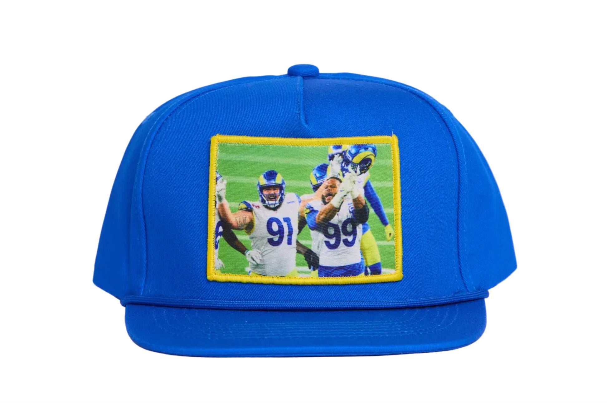 A blue hat featuring a photographic patch of Aaron Donald and Greg Gaines celebrating their Super Bowl win. 