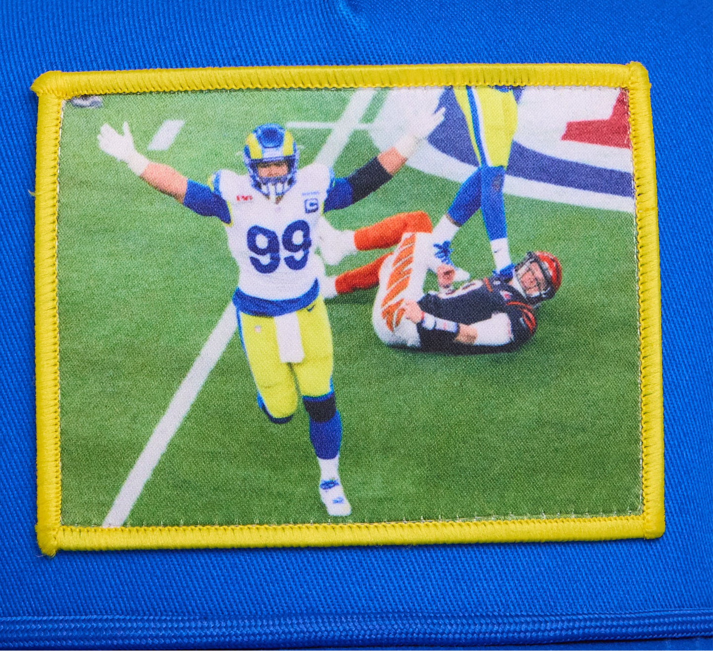 Blue hat with a patch featuring Aaron Donald celebrating a sack to win the Super Bowl