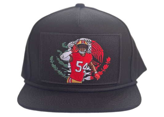 A black snapback hat featuring a rectangular embroidered patch on the front with a football player in a red jersey and the number 54, set against a plain white background.