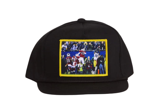 Black hat featuring a patch with Santonio Holmes catching a touchdown