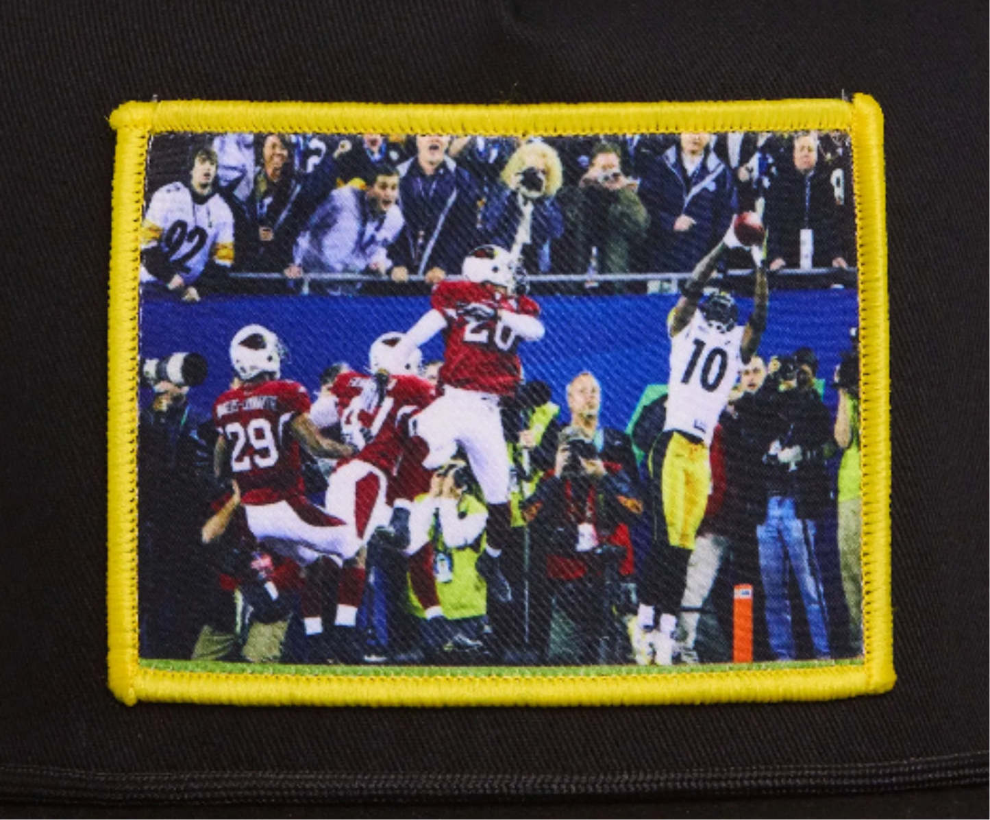 Black hat featuring a patch with Santonio Holmes catching a touchdown