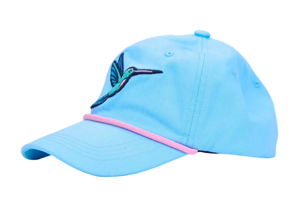 A light blue baseball cap featuring a colorful embroidered hummingbird on the side and a pink accent stripe along the edge of the brim, set against a plain white background.