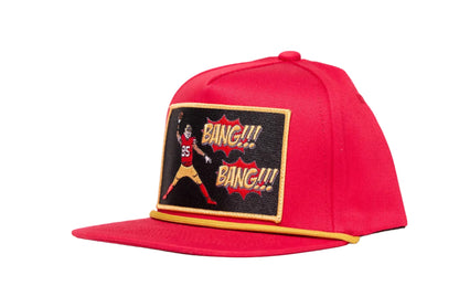 Red hat with George Kittle spiking a football with a Bang Bang 