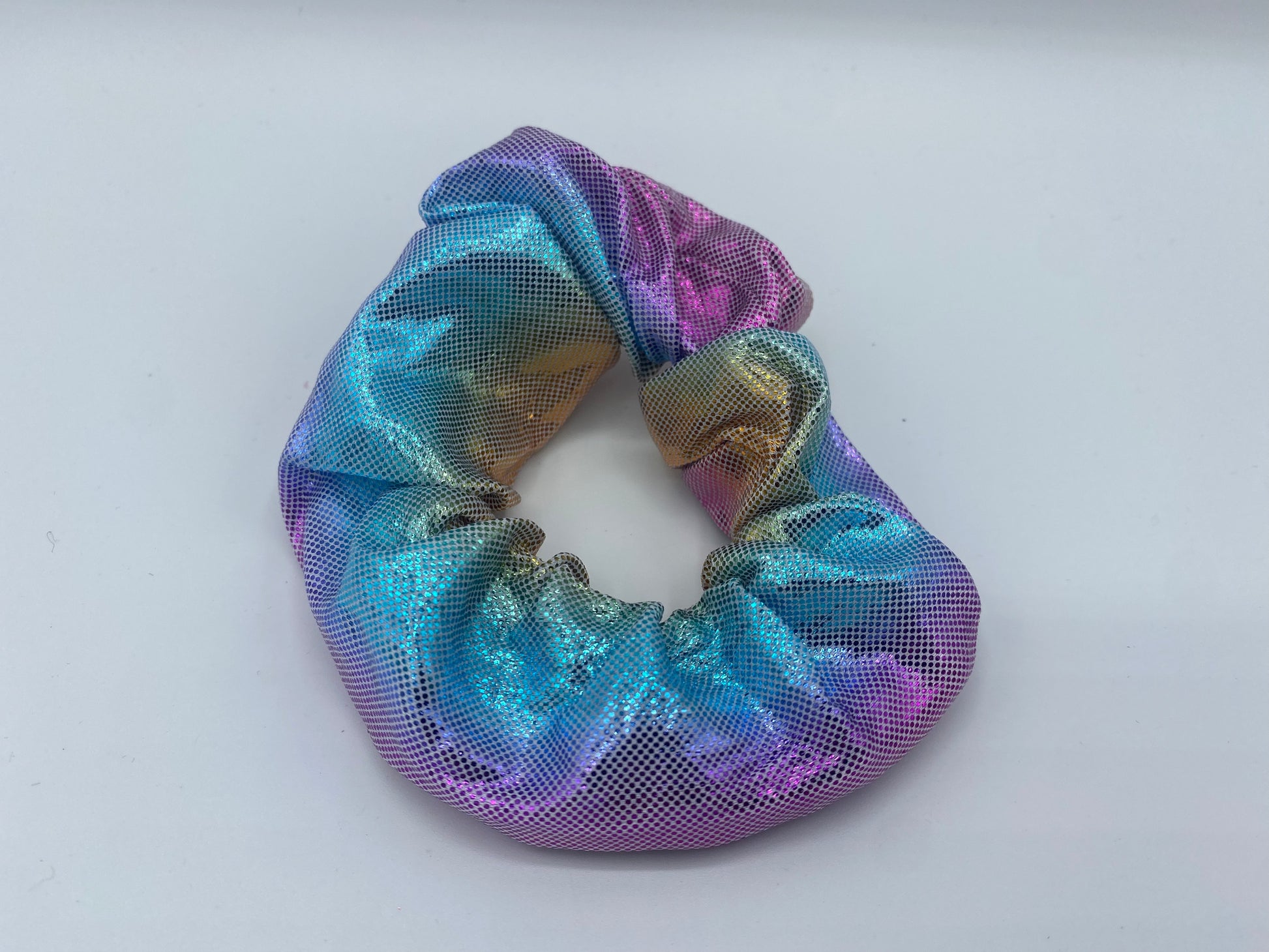 A pink and blue velvet scrunchie with a soft, plush texture, featuring a hidden pocket for discreet storage of small items.