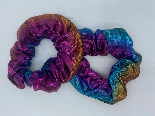 A metallic blue, pink, and gold velvet scrunchie with a soft, plush texture, featuring a hidden pocket for discreet storage of small items.