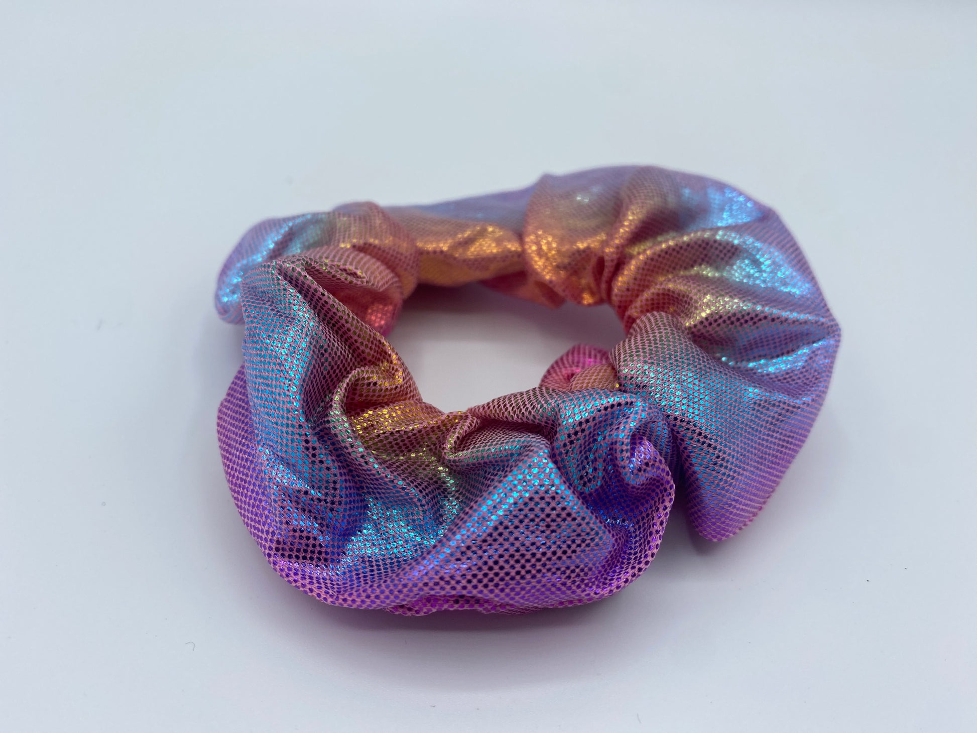 A blue velvet scrunchie with a soft, plush texture, featuring a hidden pocket for discreet storage of small items.