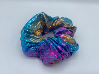 A purple and blue velvet scrunchie with a soft, plush texture, featuring a hidden pocket for discreet storage of small items.