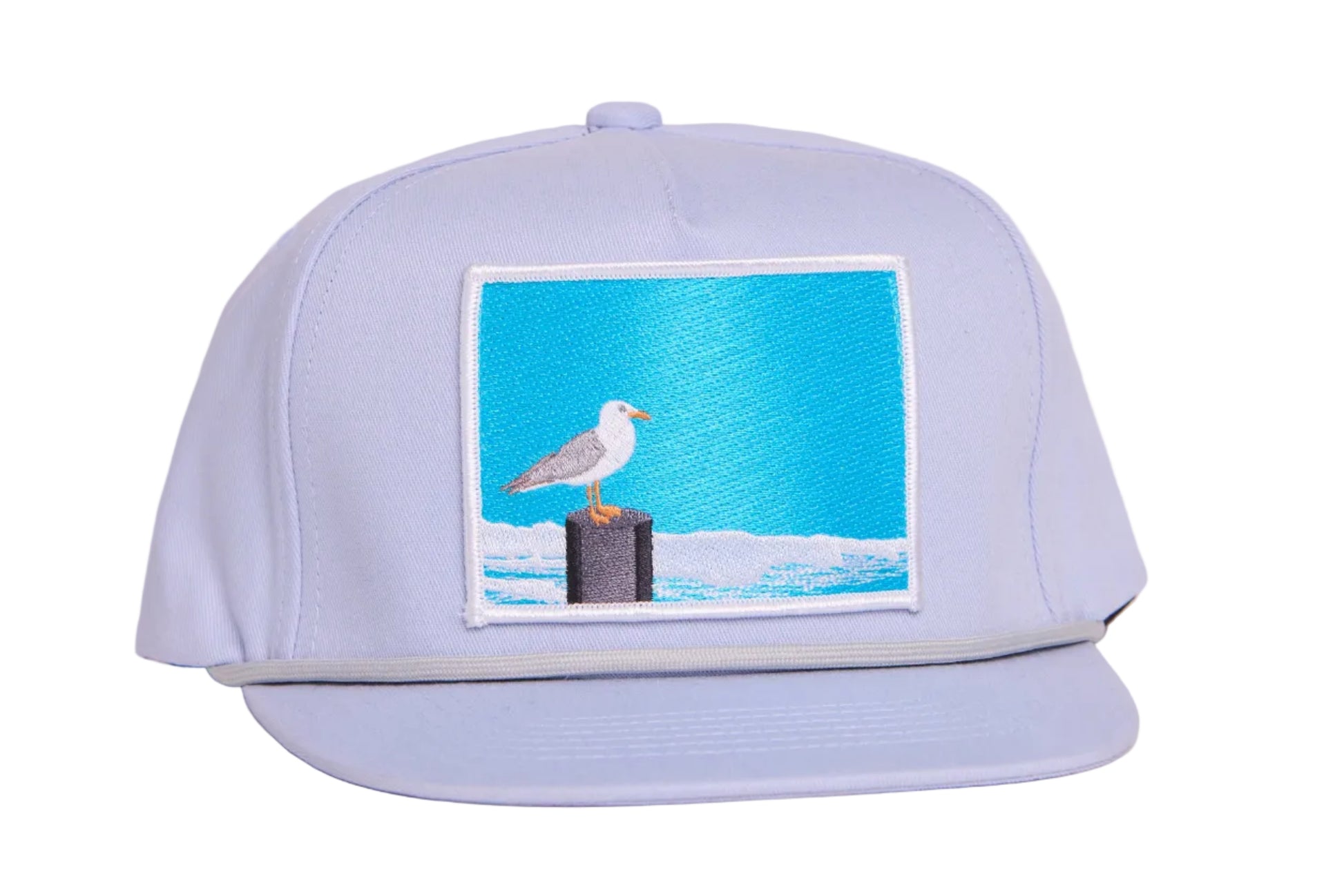 Grey ball cap with blue embroidered patch with a seagull design
