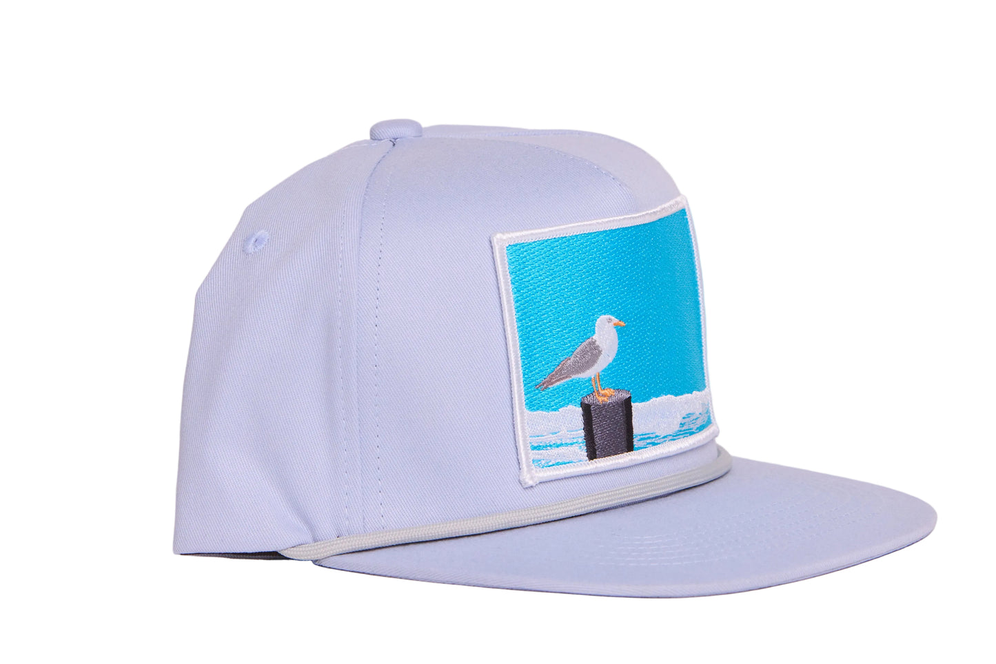 Grey ball cap with blue embroidered patch with a seagull design
