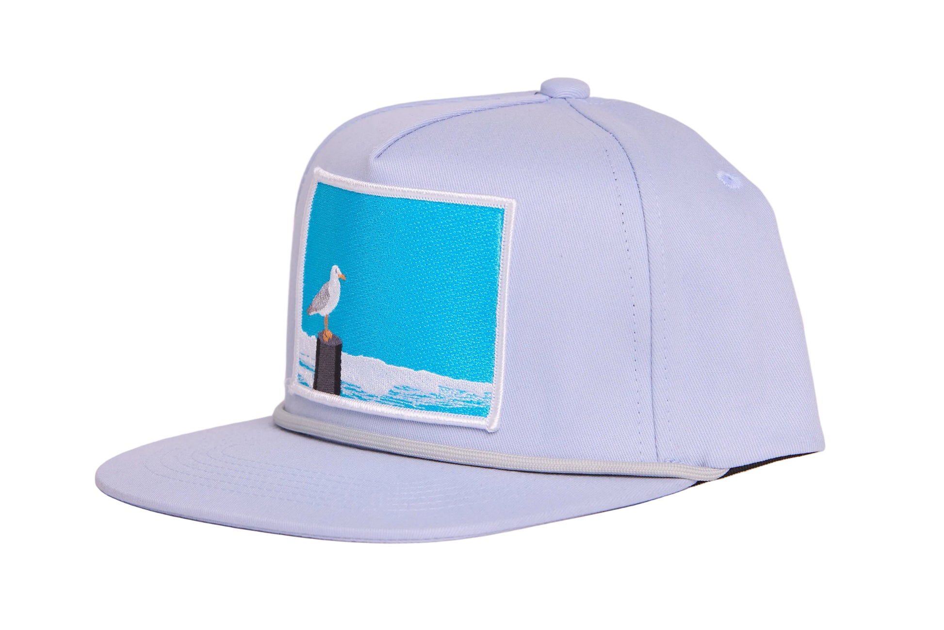 Grey ball cap with blue embroidered patch with a seagull design