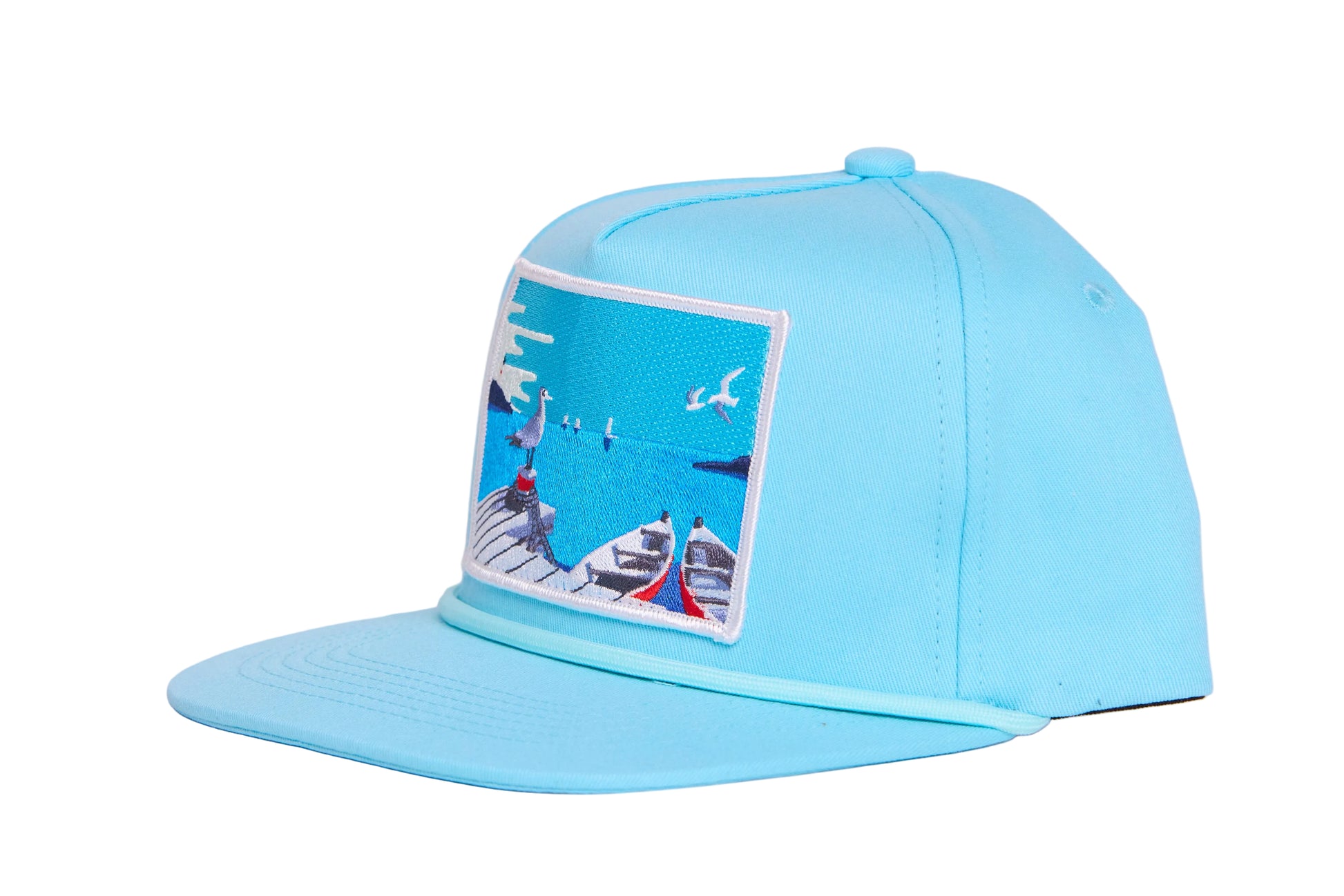 Aqua blue flat bill hat with a patch on the front featuring an ocean pier with a seagull and a boat