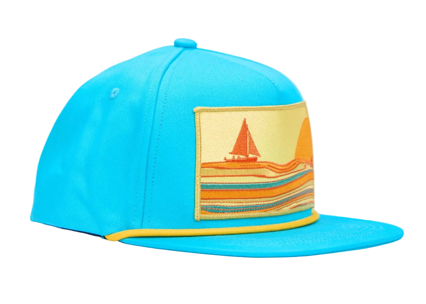 A bright turquoise blue flat-brim cap with a yellow embroidered stripe along the edge of the brim and a rectangular embroidered patch on the front depicting a sailboat on a beach. The cap is shown from a three-quarter angle against a plain white background.