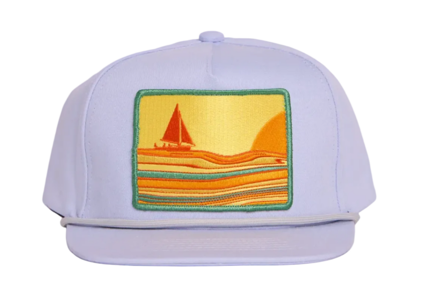 A light grey flat-brim cap featuring a square embroidered patch on the front with a sailboat and sunset scene in yellow, orange, and green.