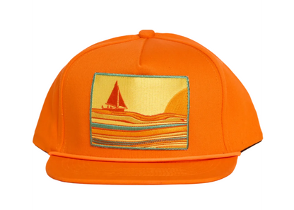 Bright orange baseball cap featuring a rectangular embroidered patch on the front with a sailboat and striped landscape design in yellow, orange, and blue.