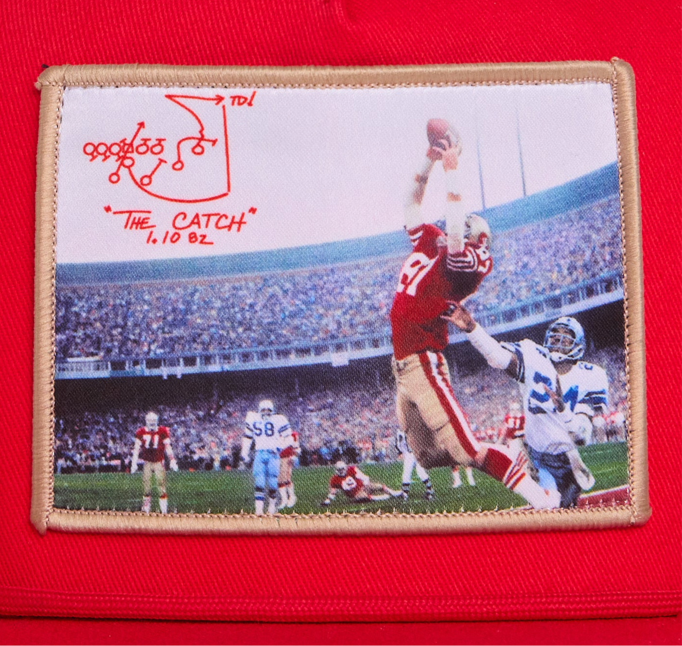 Red hat featuring a photographic patch with an image of The Catch, the legendary touchdown caught by Dwight Clark of the 49ers