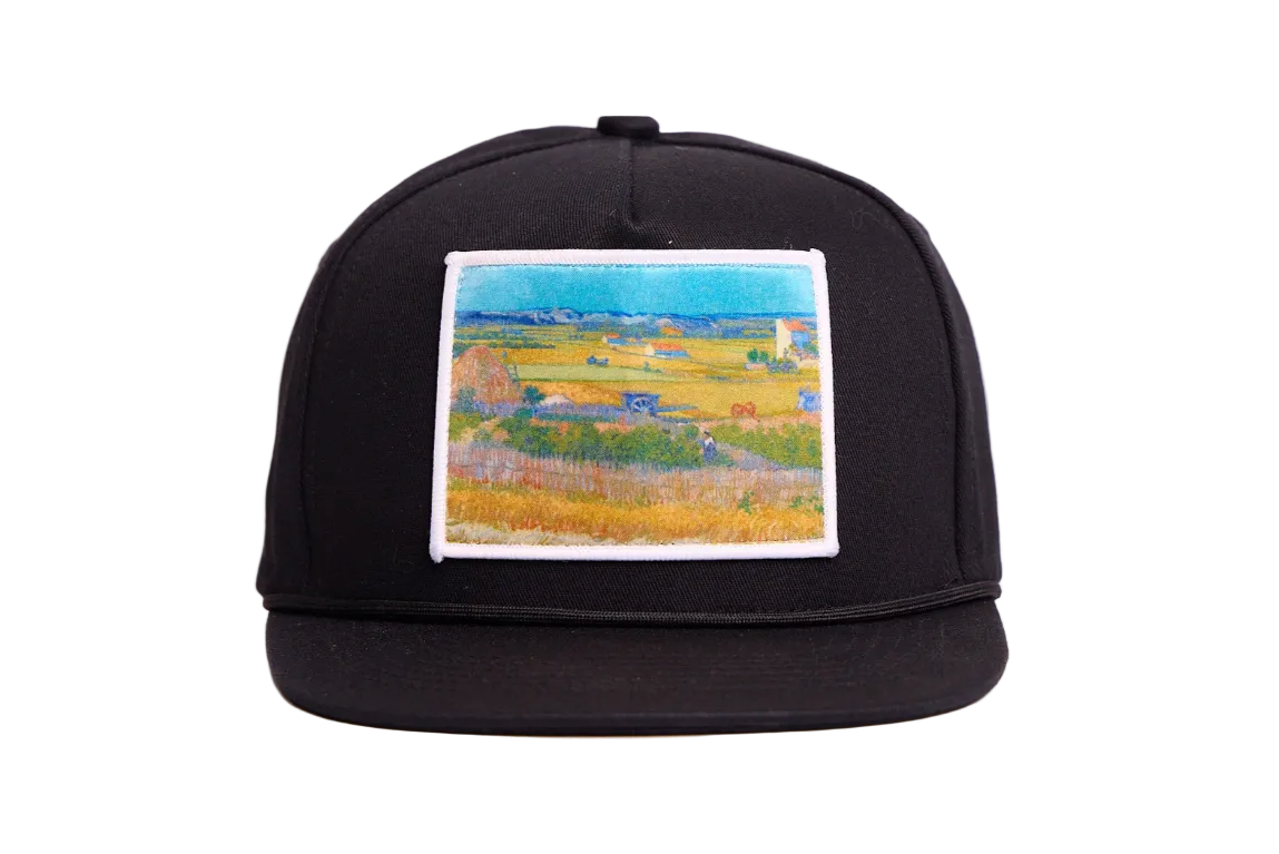 Black flat bill hat with an image of Van Gogh's painting The Harvest