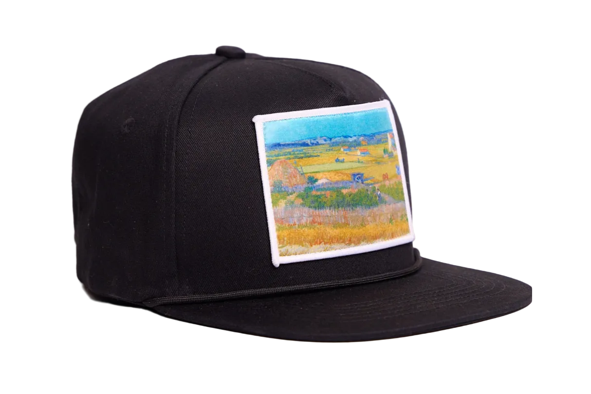 Black flat bill hat with an image of Van Gogh's painting The Harvest