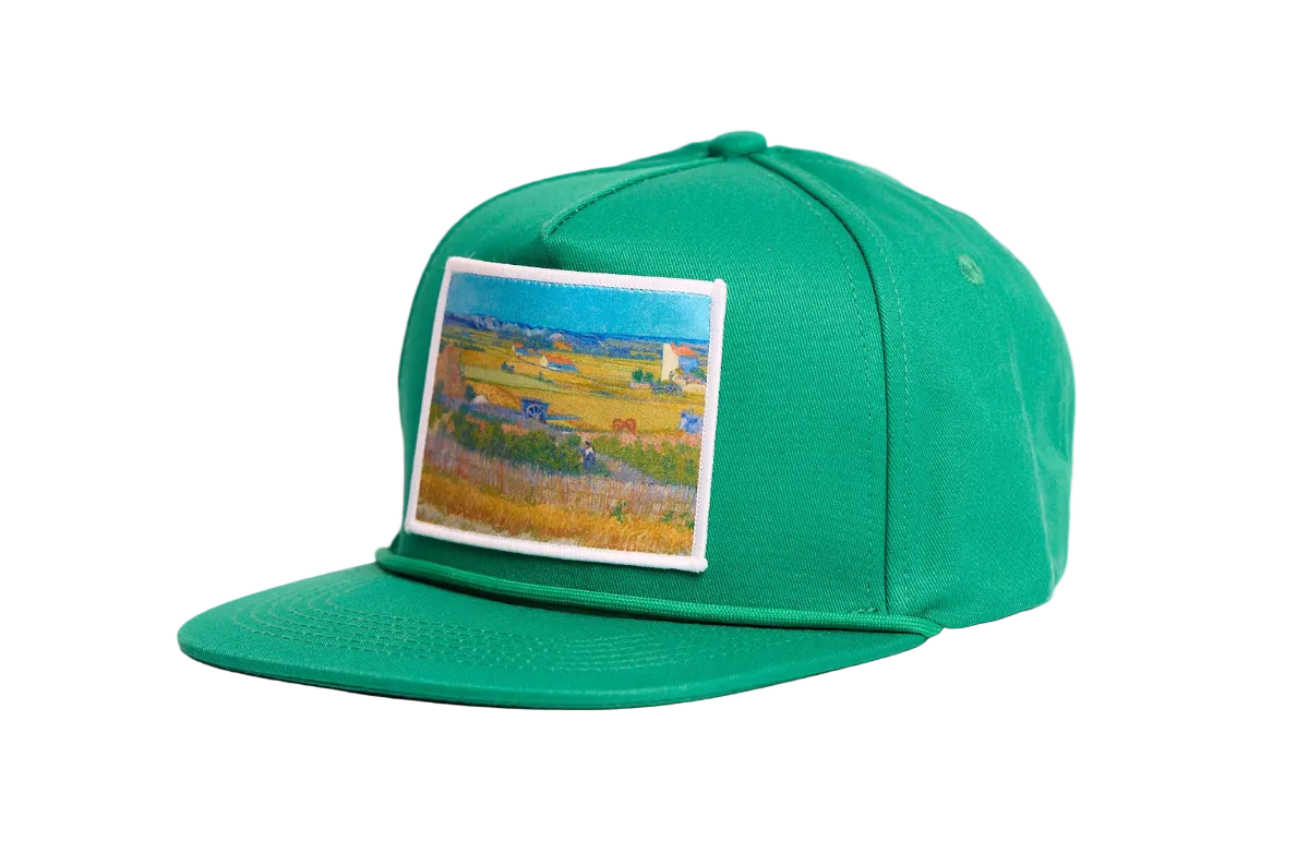 Green flat bill hat with an image of Van Gogh's painting The Harvest