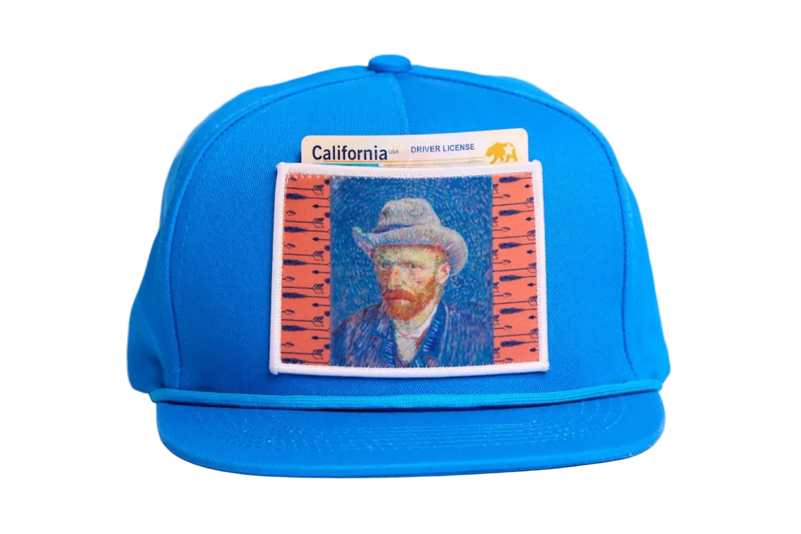 Blue flat-bill hat featuring a patch of Vincent Van Gogh's self portrait in grey felt hat