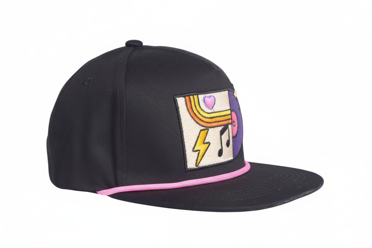 Black flat-bill hat with colorful embroidered graphic depicting a vinyl record album with a heart, lightning bolt, and music note